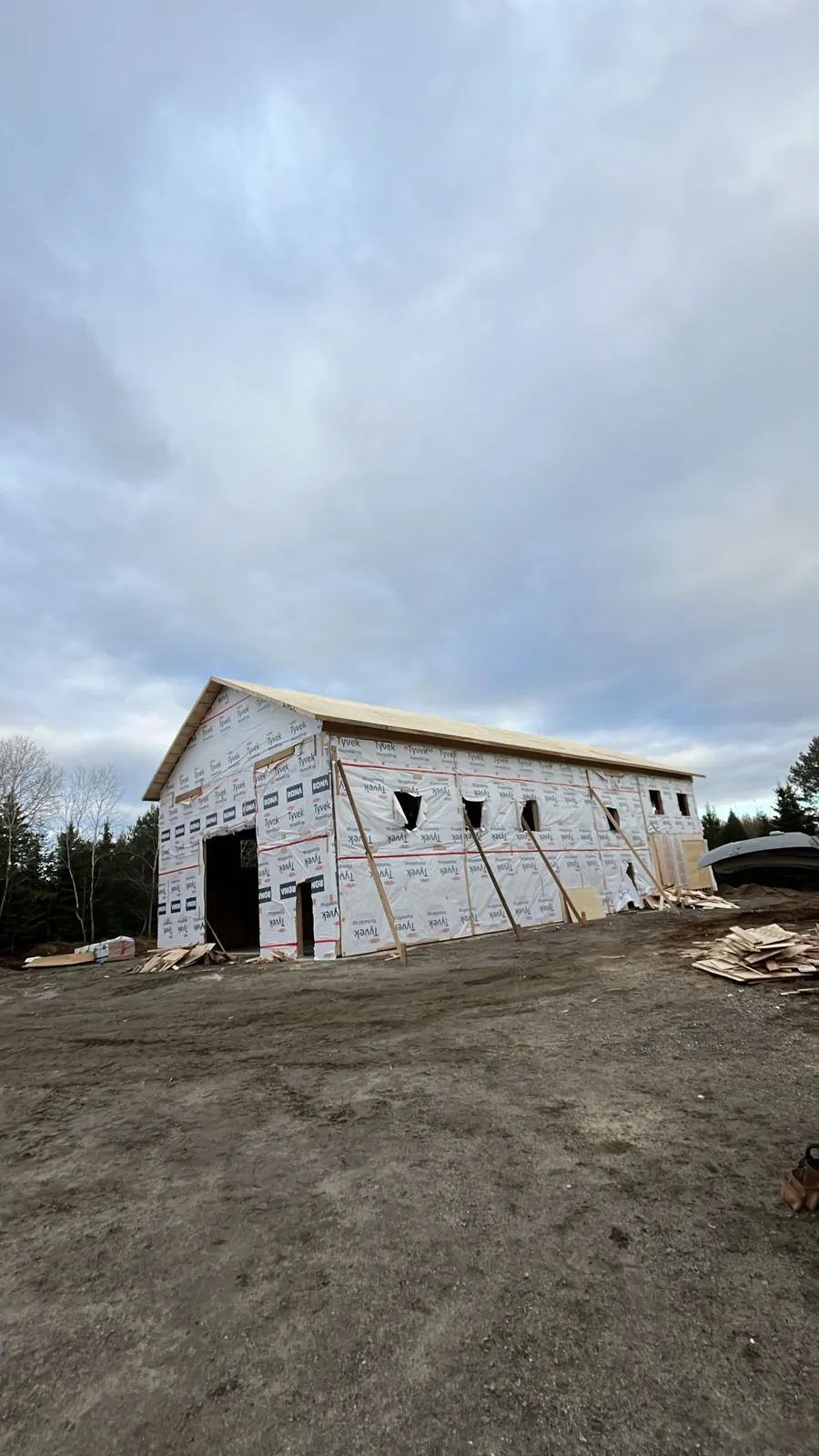 Large framed building wrapped and ready for siding